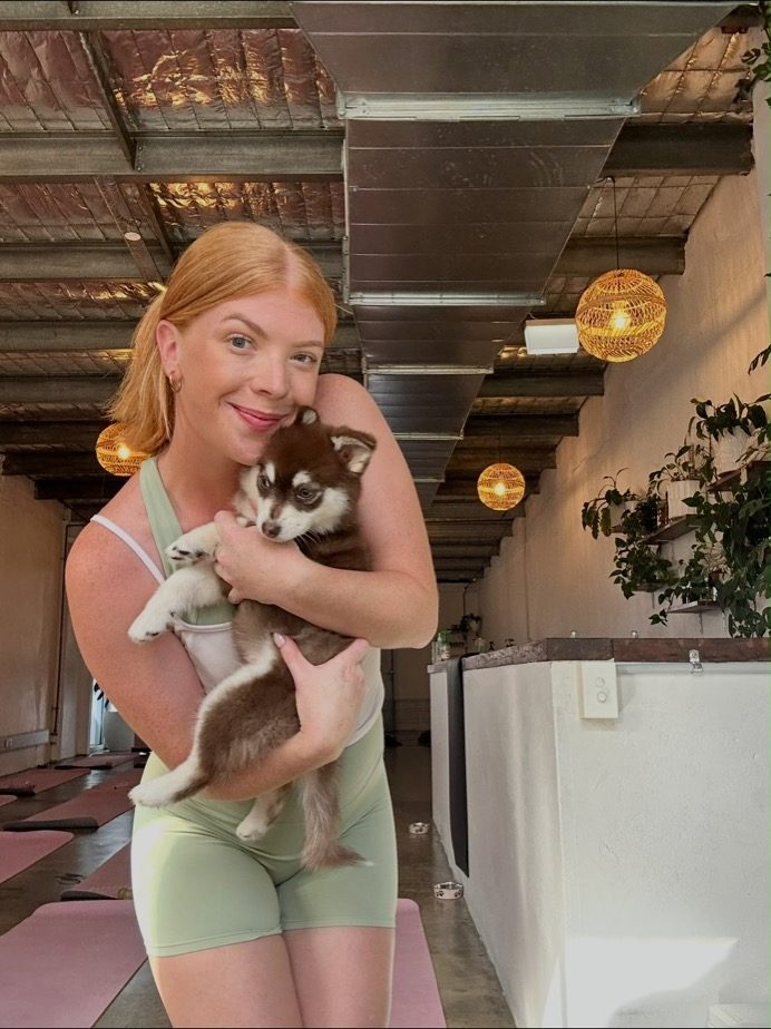 Nicole cuddling a puppy